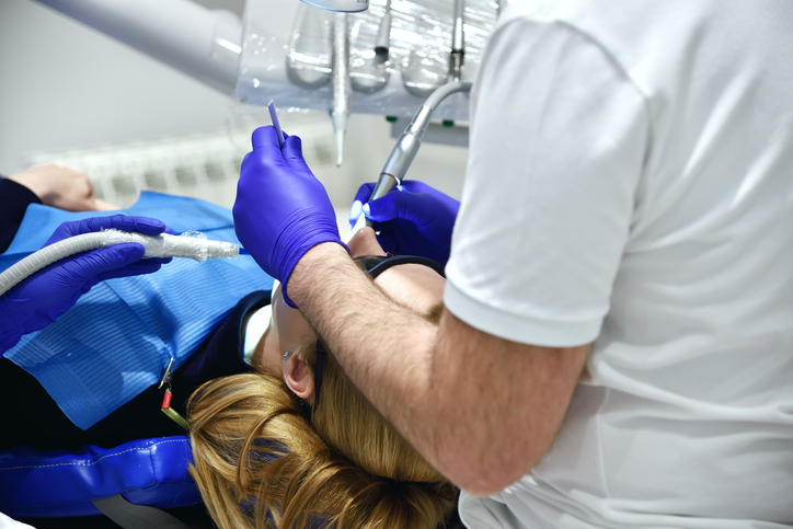 Woman Patient With Open Mouth During Oral Checkup.
