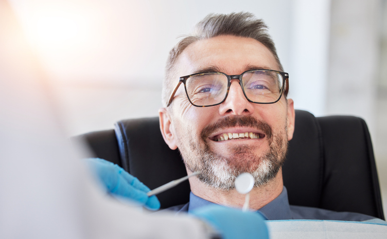 Senior man, smile and teeth, dentist and metal tools with health consultation, dental and oral care at clinic. Orthodontist, healthcare and medical check, gingivitis and cleaning mouth with wellness